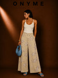 Pantalone beige con fiori ricamati in paillettes